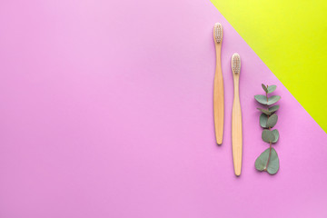 Wooden tooth brushes on color background