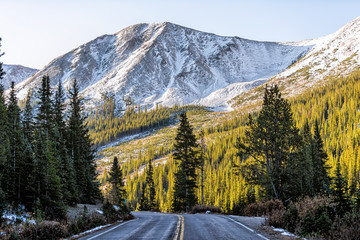 Independence Pass snow rocky mountain view and paved road scenic byway in morning sunrise near...