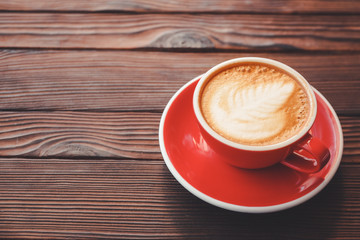 Cup of tasty cappuccino on wooden table
