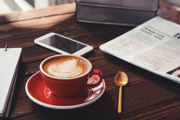 Cup of tasty cappuccino on wooden table