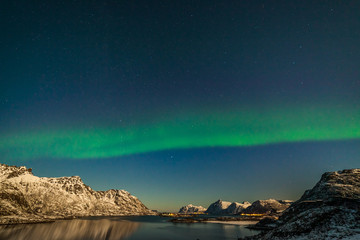 Naklejka na ściany i meble The polar arctic Northern lights hunting aurora borealis sky star in Norway travel photographer mountains. long shutter speed.