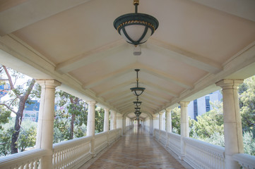 Empty corridor with classical columns on either side