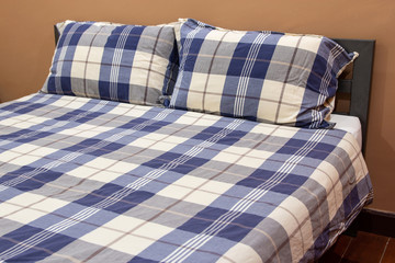 Plaid Bed with Pillow in The Bedroom Interior