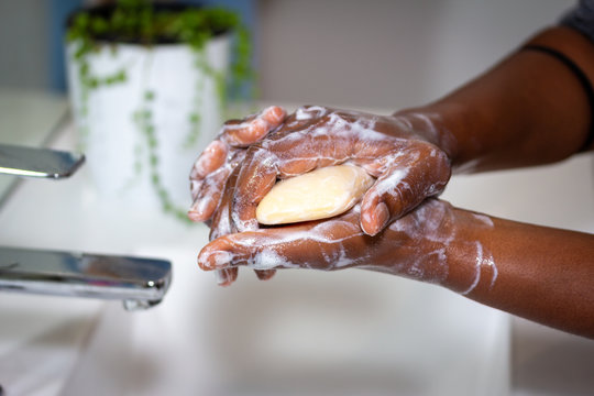 Close Up Of Black African Australian Woman Washing Hands With Soap In Sink