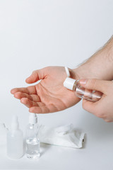 Applying alcohol sanitizer gel or antibacterial gel at adult male arm to prevent spread of virus, bacteria and coronavirus. Personal hygiene disinfectant  concept