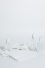 Antiseptic gel, sanitary napkins, medical  mask, antibacterial spray on a white background.  Personal protective hygiene concept.  Prevention of coronavirus disease (COVID-19) . Copy space