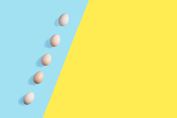 5 brown eggs on the flat background with geometric arragngment
