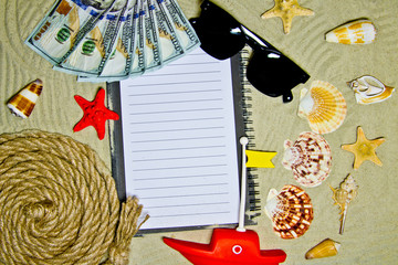 Vacation, travel and summer concept - laptop with sand beach accessories and seashells