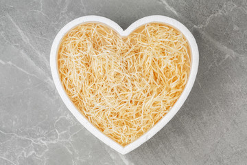 Heart box filled with hay.
