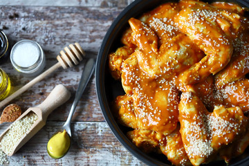 Raw chicken wings marinated in a frying pan before cooking. Cooking chicken wings. Buffalo wings recipe. Keto Paleo. Pegan.