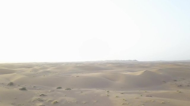 Panoramic beautiful top view of the Maranjob desert. A drone flies over the sands and dunes. Visible sand, grass, shrubs.