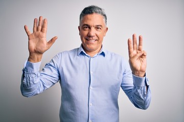 Middle age handsome grey-haired business man wearing elegant shirt over white background showing and pointing up with fingers number eight while smiling confident and happy.