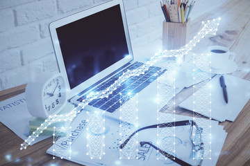 Financial market graph hologram and personal computer on background. Multi exposure. Concept of forex.