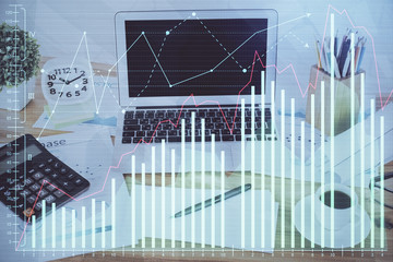 Financial graph colorful drawing and table with computer on background. Double exposure. Concept of international markets.