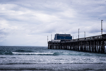 Ocean Waves Crashing Under a Pier