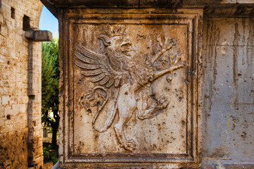 Griffon symbol of  Perugia in Umbria on medieval Gate of St Luke in the city historic center - obrazy, fototapety, plakaty