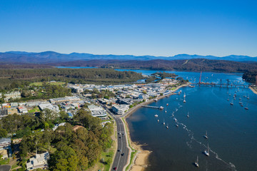Panoramic aerial drone view of Batemans Bay on the New South Wales South Coast, Australia, looking toward Clyde River and Clyde River Bridge, on a sunny day 