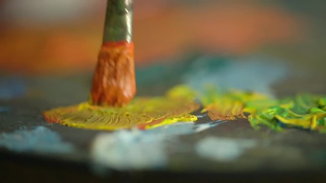 Close-up of brush with paint artist canvas