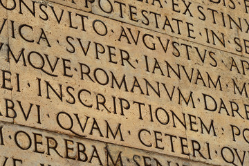 Latin ancient language and classical education. Inscription from Emperor Augustus famous Res Gestae (1st century AD), with the word Romanum in the center - obrazy, fototapety, plakaty