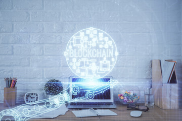 Multi exposure of blockchain and crypto economy theme hologram and table with computer background. Concept of bitcoin cryptocurrency.