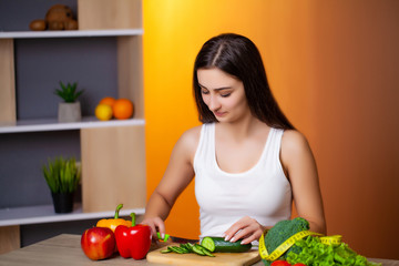 Young beautiful woman preparing wholesome diet salad