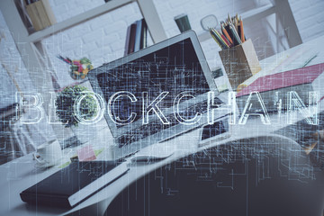 Multi exposure of blockchain and crypto economy theme hologram and table with computer background. Concept of bitcoin cryptocurrency.