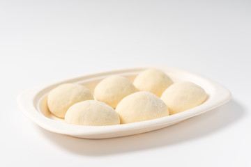 A dish of Chinese bread on a white background
