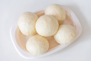 A dish of Chinese bread on a white background