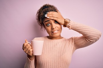 Young african american afro girl drinking cup of coffee over isolated pink background stressed with hand on head, shocked with shame and surprise face, angry and frustrated. Fear and upset
