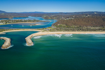 Obraz premium Aerial drone view of Wagonga Head and Wagonga Inlet at Narooma on the New South Wales South Coast, Australia, on a sunny day 