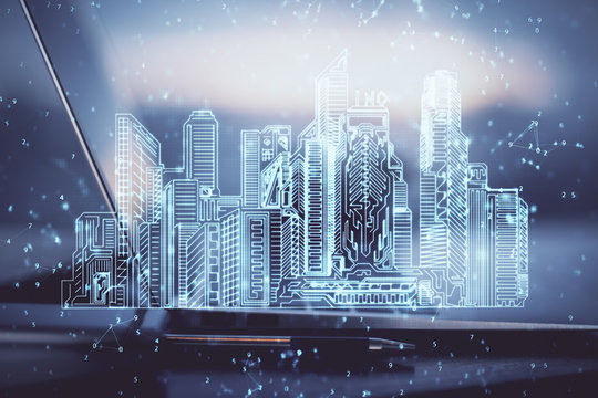 Desktop Computer Background In Office And Big Town Buildings Hologram Drawing. Double Exposure. Smart City Concept.