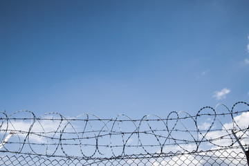 barbed wire on empty light blue sky background