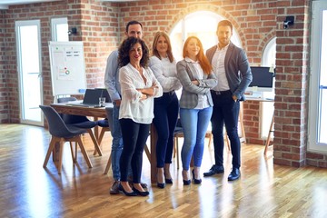 Group of business workers smiling happy and confident. Posing together with smile on face looking at the camera at the office