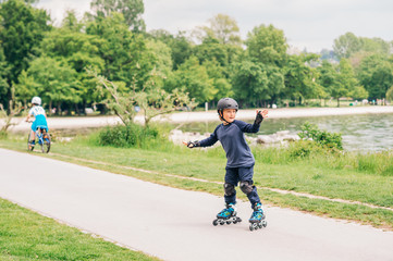 Active little boy skating in summer park, healthy lifestyle for children
