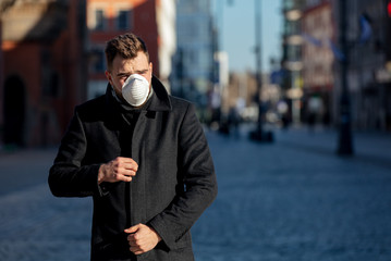 Style guy in mask on city street in Wroclaw, Poland
