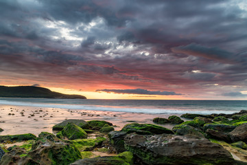 Moody Clouds and Green Mossy Rocks at the Seaside