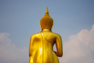 The back of the golden Buddha and the bright sky