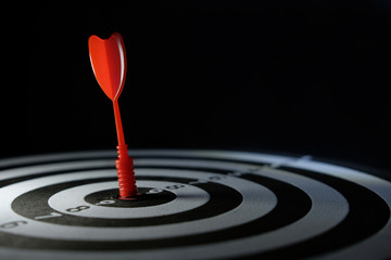 Conceptual photo of business strategy / accuracy - a red arrow that sticks directly in the center...