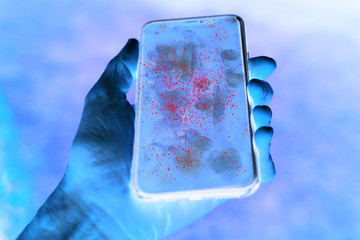 Dirty mobile phone screen with invisible germs shown in contrast