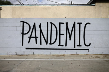 Coronavirus pandemic graffiti spray painted on brick wall