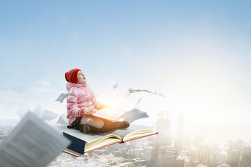 Little girl reading a book