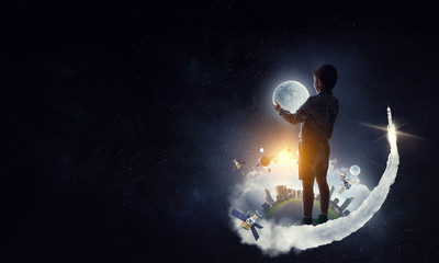Obraz na płótnie Canvas Boy holding moon at night