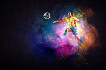 Boy playing soccer hitting the ball