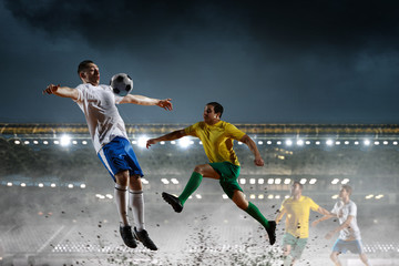 Obraz na płótnie Canvas Soccer players on stadium in action. Mixed media