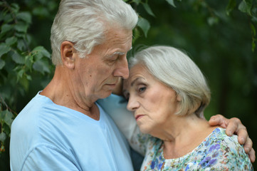 Portrait of unhappy senior couple in the park