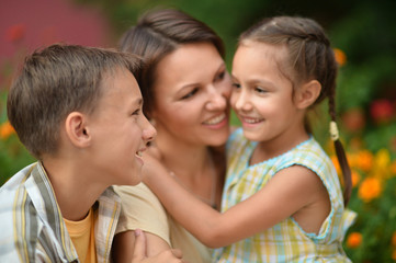 Portrait of happy mother and children in park