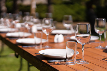 Served wooden table without a tablecloth. Cafe in the open air park