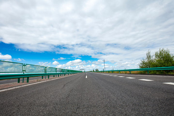 Empty highway, blue sky and white clouds landscape