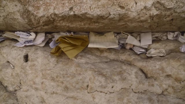 Religious prayers and notes stuffed into the cracks of the Western Wall in Jerusalem, Israel. Jewish and Islamic alike frequently visit this area.