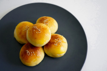 Chinese dessert: a plate of small bread filled with bean paste. Chinese breakfast on a plate of small bread filled with bean paste.